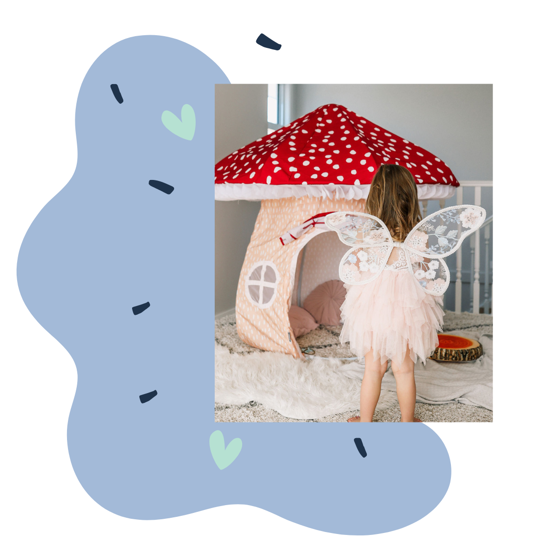 Image of little girl standing in front of Petite Maison Play magical mushroom cubby with fairy wings