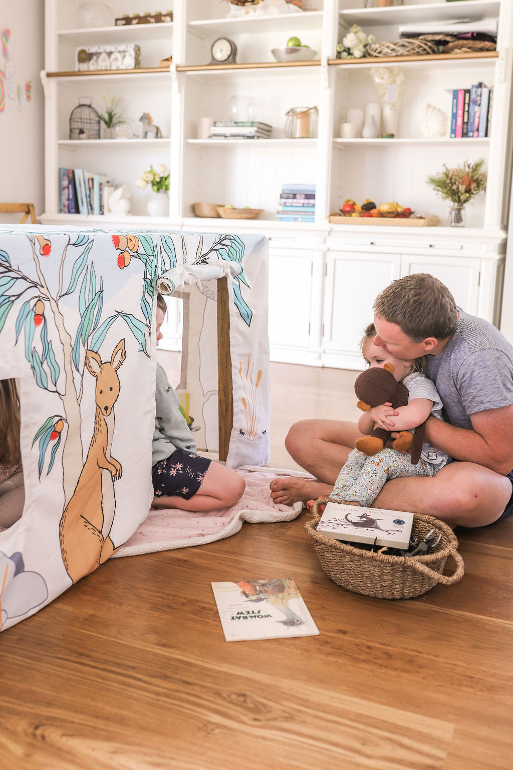 Image of small child and father sitting outside Petite Maison Play Aussie Bush Table Tent cubby