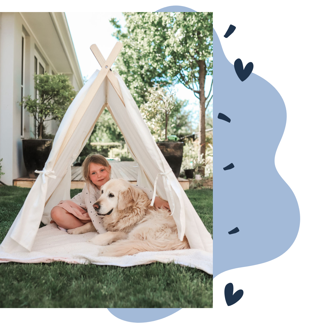 Image of young child and dog sitting in Petite Maison Play Safari Tent cubby House. 