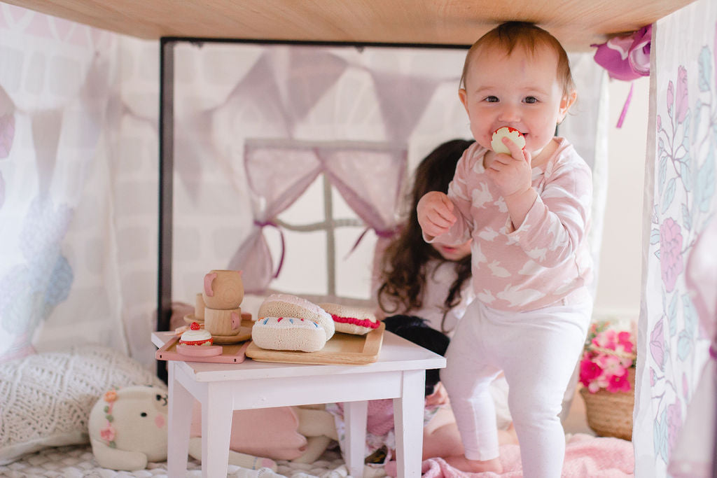 Baby playing in Petite Maison Play Home Sweet Home TableTent cubby house